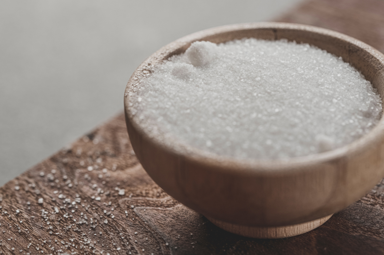 A bowl of sugar on a wooden table, meant to represent diabetes – Viome Oral Health Intelligence Test 
