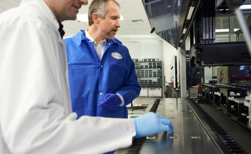 Two health scientists working in a lab and overseeing production for Viome supplements.